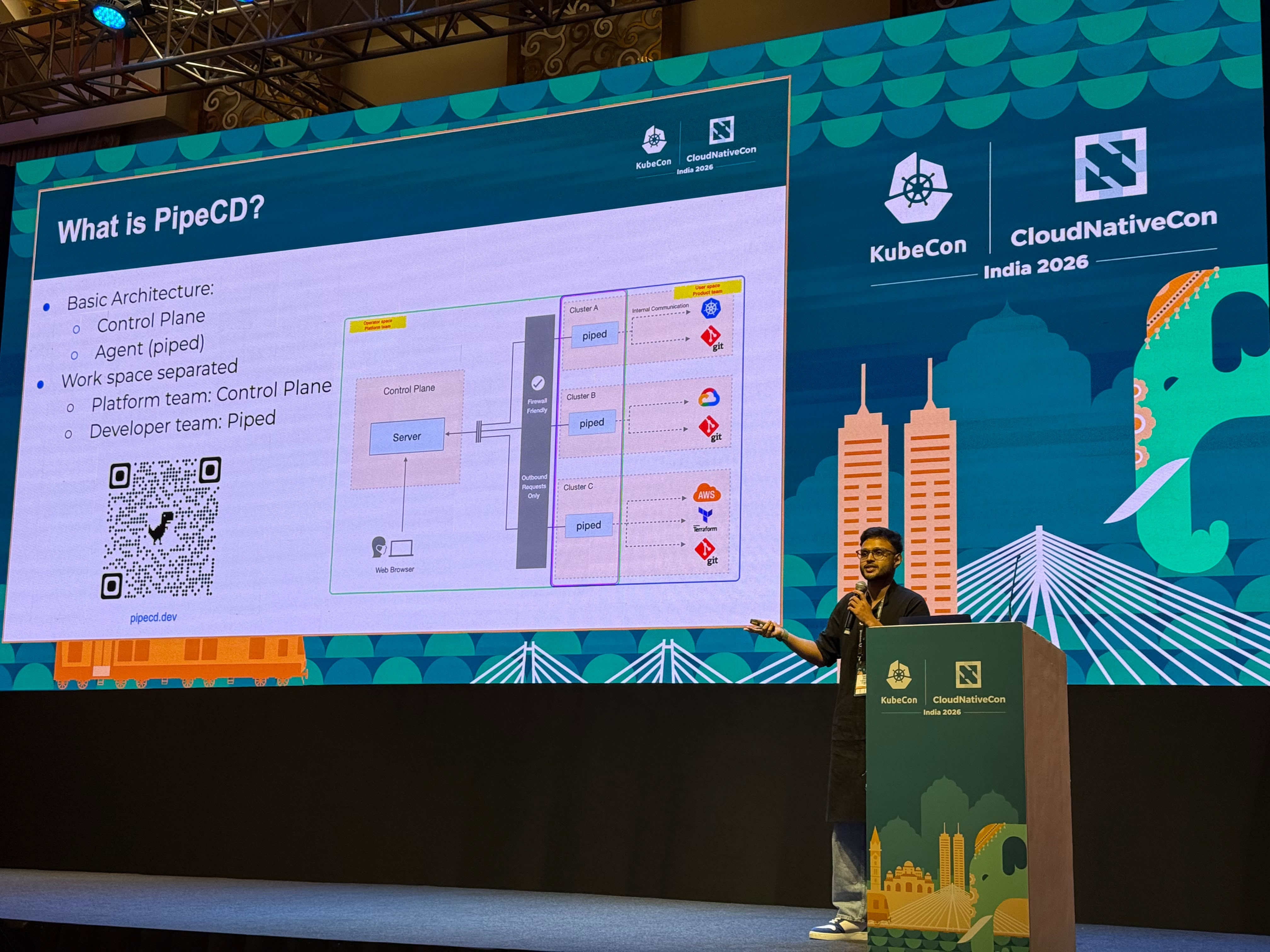 Eeshaan Sawant on stage delivering the GitOps Without Boundaries talk at KubeCon India 2026